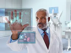 Black doctor looking at digital display in doctor's office