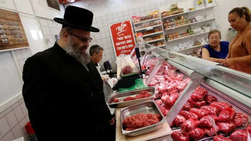 Kosher inspector Aaron Wulkan examines display refrigerators containing meat in a food store to ensure that the food is stored and prepared according to Jewish regulations and customs in Bat Yam, Israel, October 31, 2016.REUTERS/Baz Ratner