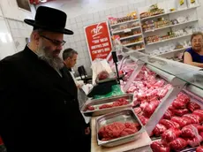 Kosher inspector Aaron Wulkan examines display refrigerators containing meat in a food store to ensure that the food is stored and prepared according to Jewish regulations and customs in Bat Yam, Israel, October 31, 2016.REUTERS/Baz Ratner