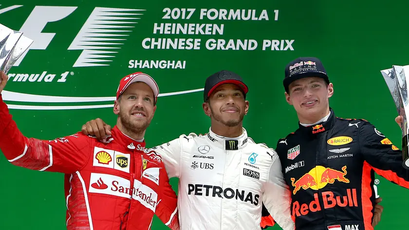 (170409) -- SHANGHAI, April 9, 2017 (Xinhua) -- Mercedes driver Lewis Hamilton (C)of Britain, Ferrari driver Sebastian Vettel(L) of Germany and Red Bull Racing driver Max Verstappen of the Netherlands celebrate on the podium after the Formula One Chinese Grand Prix at the Shanghai International Circuit in Shanghai, east China, April 9, 2017. (Xinhua/Fan Jun)