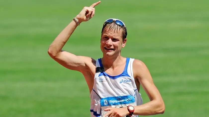 Alex Schwazer of Italy holds up his finger as number one as he wins gold in the men's 50km walk during the Beijing 2008 Olympic Games in the National Stadium, Beijing, China, 22 August 2008. ANSA/GERO BRELOER