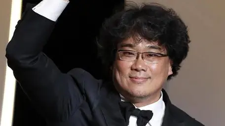 epa07600297 South Korean director Bong Joon-ho reacts after winning the Palme d'Or (Golden Palm) for the movie 'Parasite' during the Closing Awards Ceremony of the 72nd Cannes Film Festival, in Cannes, France, 25 May 2019. The Golden Palm winning movie will be screened after the closing ceremony. EPA/GUILLAUME HORCAJUELO