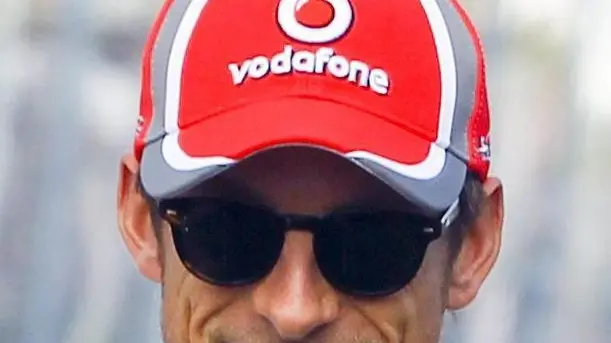 epa03150097 British Formula One driver Jenson Button of McLaren Mercedes gives a thumbs up at the end of the drivers' parade for the Australian Formula 1 Grand Prix at the Albert Park circuit in Melbourne, Australia, 18 March 2012. EPA/DIEGO AZUBEL