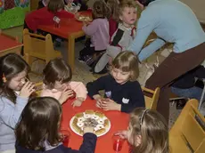 Bambini mangiano assieme all'asilo in una foto di archivio