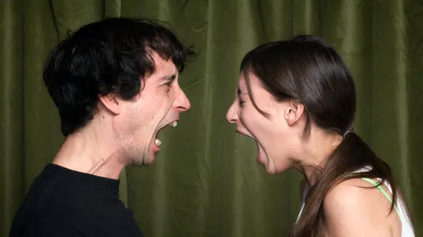 Couple yelling face to face --- Image by © John Rensten/Corbis