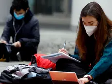 Students study on the street in front of the Palazzo della Regione Lombardia (Regional Assembly) to protest against the closure of the school imposed by the dpcm government for the increase in covid infections, Milan, Italy, 13 November 2020. ANSA/Mourad Balti Touati