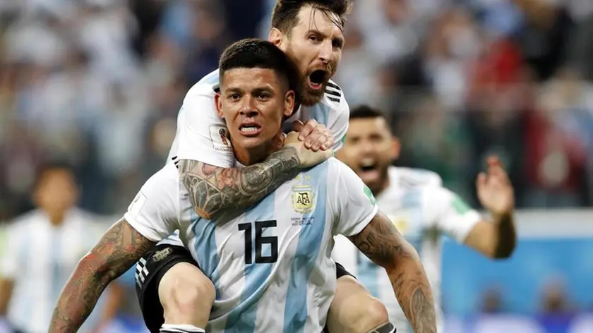 epa06842809 Marcos Rojo of Argentina celebrates with teammate Lionel Messi (top) after scoring the 2-1 during the FIFA World Cup 2018 group D preliminary round soccer match between Nigeria and Argentina in St.Petersburg, Russia, 26 June 2018. (RESTRICTIONS APPLY: Editorial Use Only, not used in association with any commercial entity - Images must not be used in any form of alert service or push service of any kind including via mobile alert services, downloads to mobile devices or MMS messaging - Images must appear as still images and must not emulate match action video footage - No alteration is made to, and no text or image is superimposed over, any published image which: (a) intentionally obscures or removes a sponsor identification image; or (b) adds or overlays the commercial identification of any third party which is not officially associated with the FIFA World Cup) EPA/ANATOLY MALTSEV EDITORIAL USE ONLY