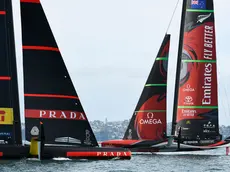 Italy's Luna Rossa, left, sails off their foils against Emirates Team New Zealand in race eight of the America's Cup on Auckland's Waitemata Harbour, Monday, March 15, 2021. (Chris Cameron/Photosport via AP)